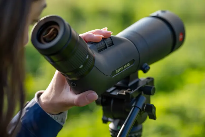 Woman looking through her Leica Televid HD spotting scope