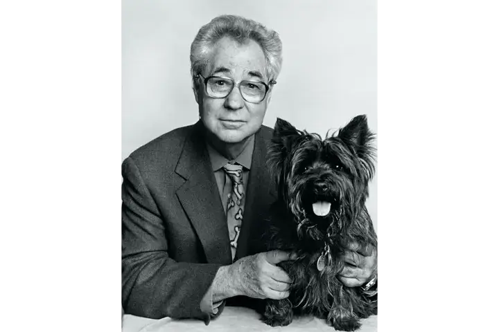 Elliott Erwitt with a dog in his arm