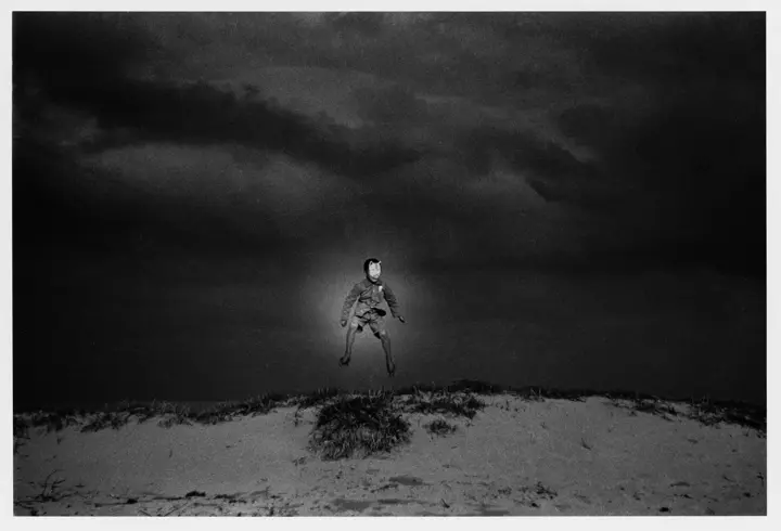 Man floating over sand