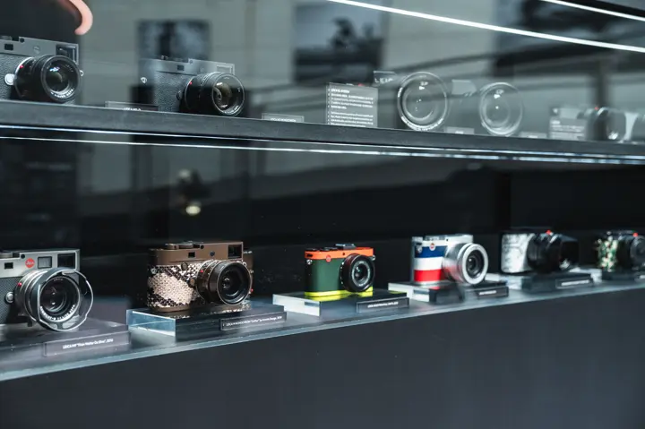 different leica camera editions in a display case