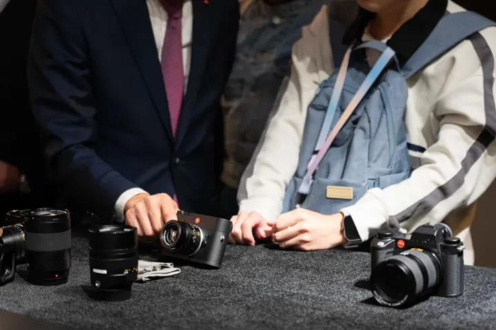 100 years of leica Tokyo, Men looking at Leica cameras