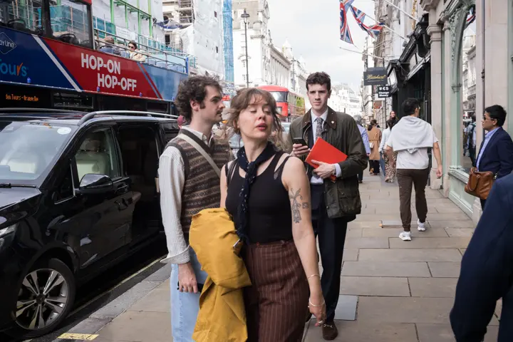 Group of people walking trough the streets of London