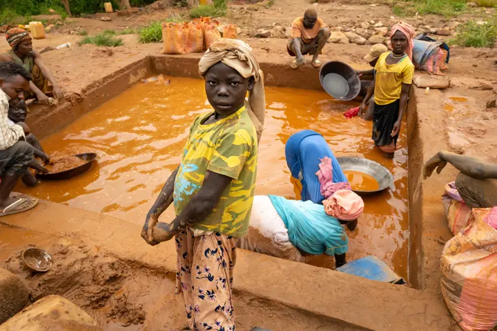 Girl Standing in Front of a Clay Puddle 