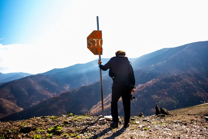 Man in an STOP sign looking down
