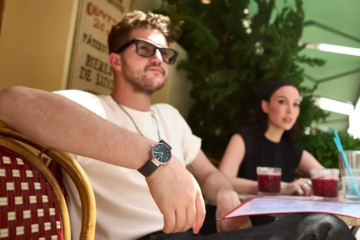Man and a woman in a cafe the man is wearing a Leica ZM Watch