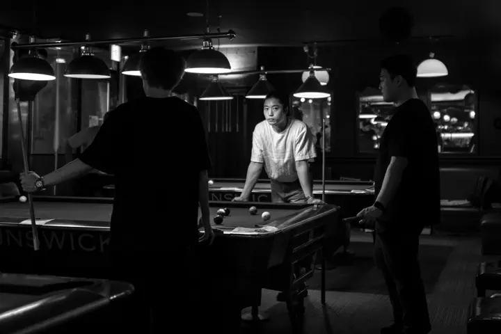 black and white photograph of people in a billiards pub