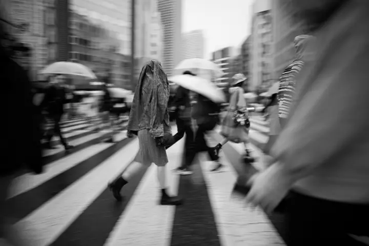 People are crossing a zebra crossing.