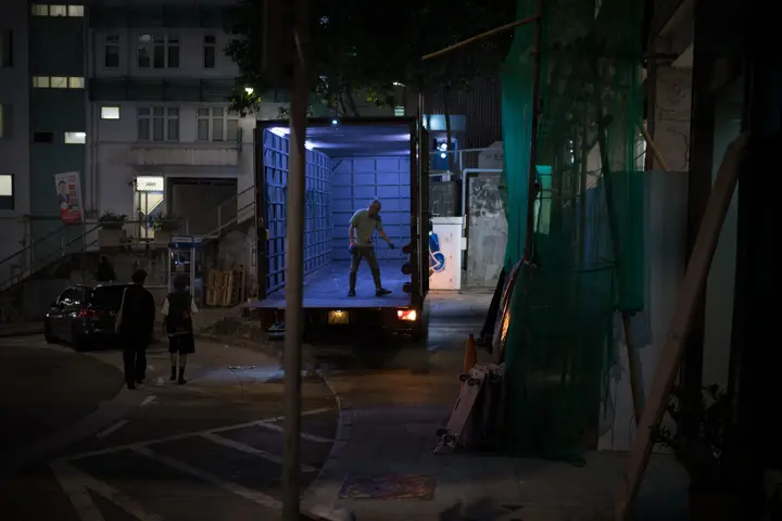 View into the open loading area of a lorry illuminated by a bluish light