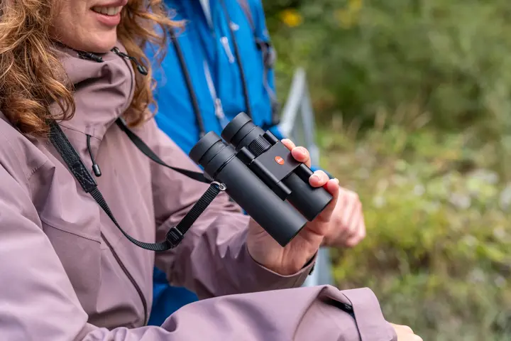 Woman is holding her Leica Noctivid Compact
