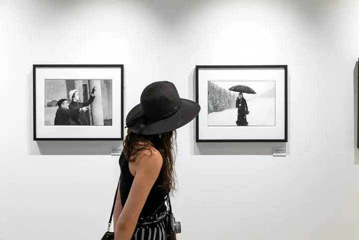 Leica Gallery Boston woman looks at photos