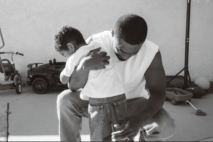 Black and white photo of interaction between man and child