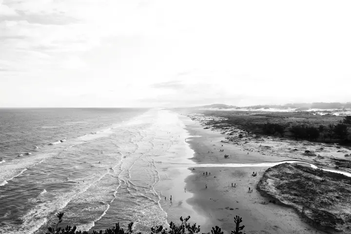 A black and white beach scene photograph.