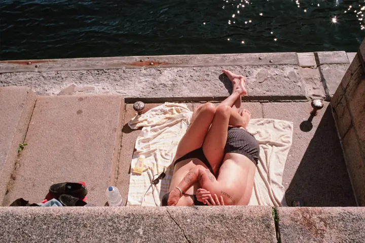A photograph of two people next to water.