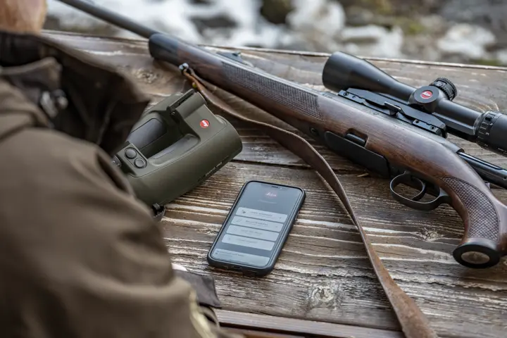 Hunter is checking his Leica Ballistics App with his Leica Geovid Pro