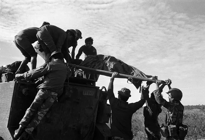 soldiers carrying a body b&w