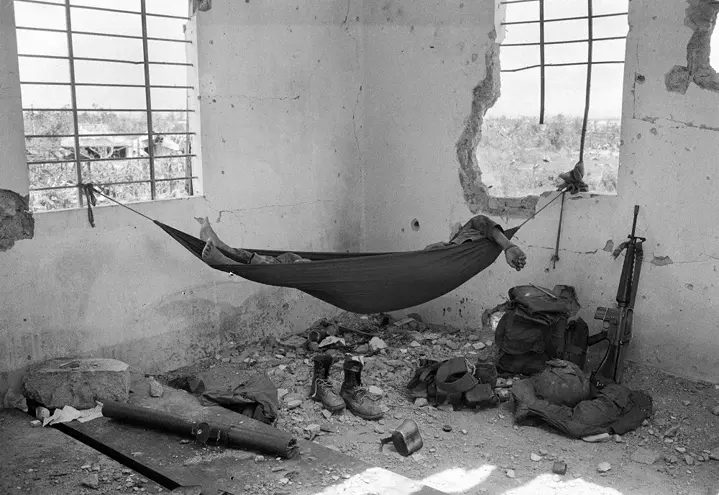 person in a hanging matress b&w