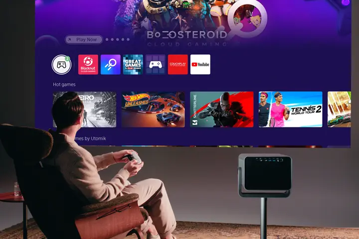 A man is sitting in an armchair playing with the Vidaa app