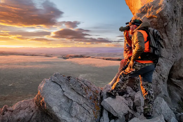 Man using his Leica Geovid Pro in olive green