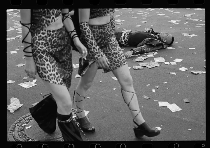 Two women in leopard-print outfits walking down the street
