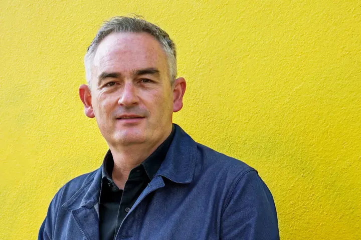 Jesse in front of a yellow wall