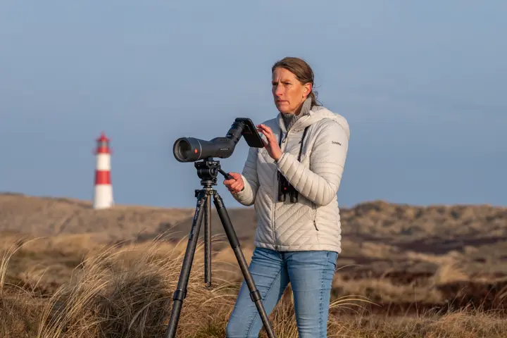 Woman is digiscoping using her Leica APO-Televid