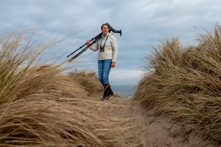 Woman on a beach with her digiscoping equipment