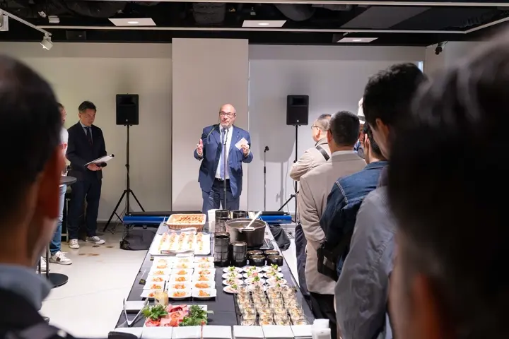 At the Leica Ginza 20th Anniversary Photo Exhibition Opening, speech during reception with catering setup