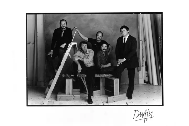 Black and white image of famous British Photographers in a studio.