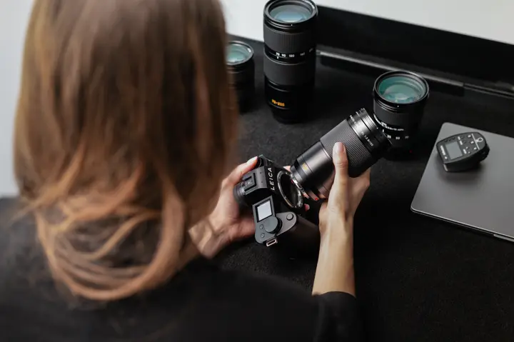 Customer evaluating a Leica camera and lens as part of a Leica Trade-In consultation.