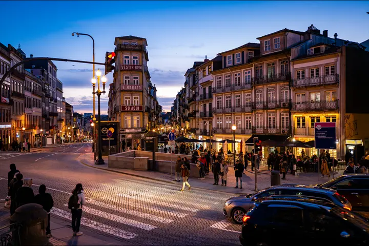 A nighttime view of a street in Porto