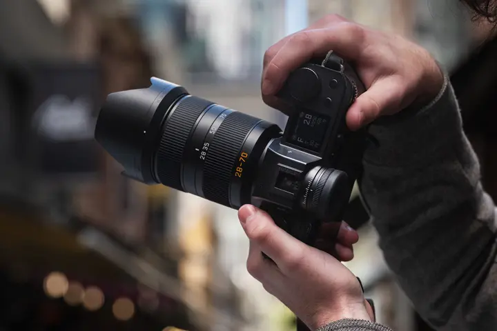 A person is taking photographs with the Leica SL camera