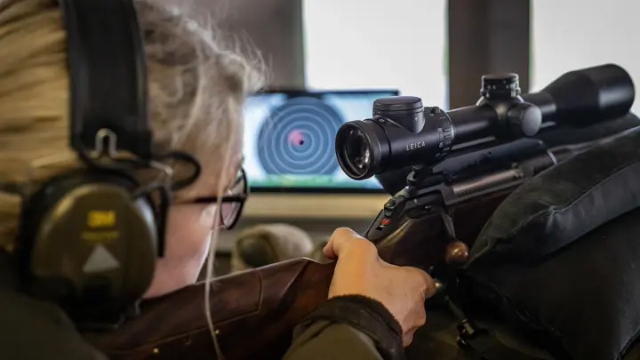 woman-using-leica-rifle-scope-at-long-range-shooting-range
