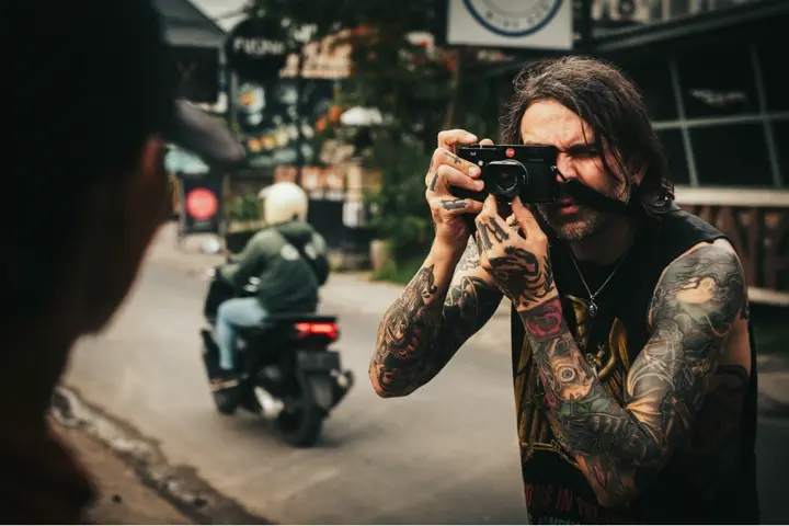 Ben Alexis is taking a photograph with the Leica M