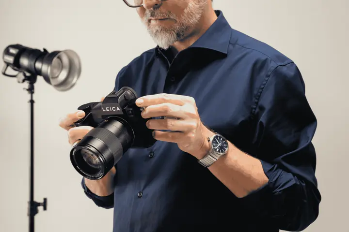 A person is holding the Leica SL3-P