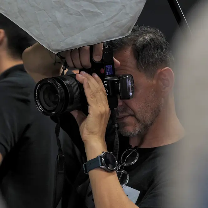 Close-up of a man taking a picture in a studio.