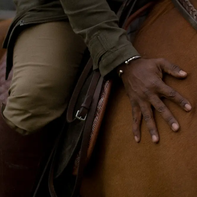 Close-up of a person sitting on a horse