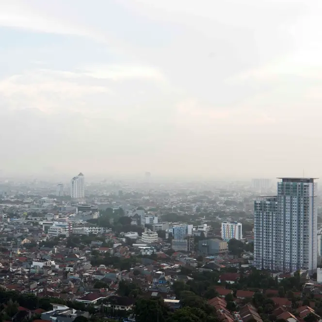 View of a foggy city with tower blocks.