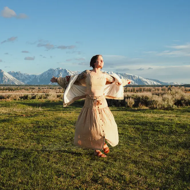 Happy woman with white dress on a meadow
