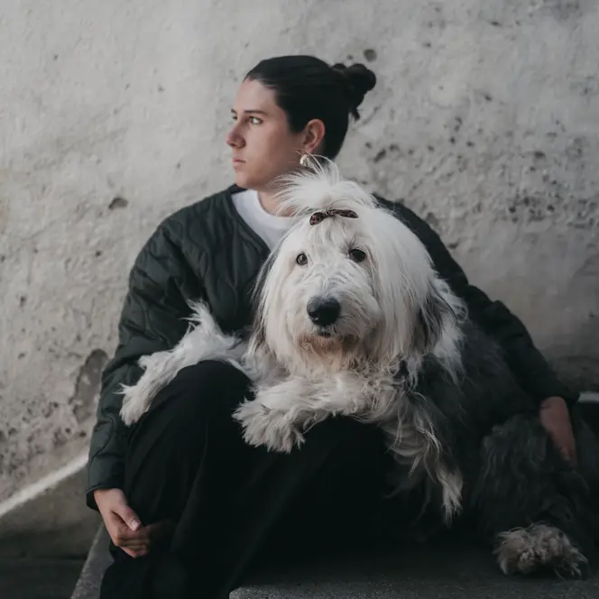 Woman sitting cross-legged on the floor with a bobtail on her lap