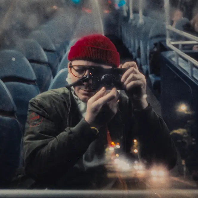 Man in a Bus with leica camera