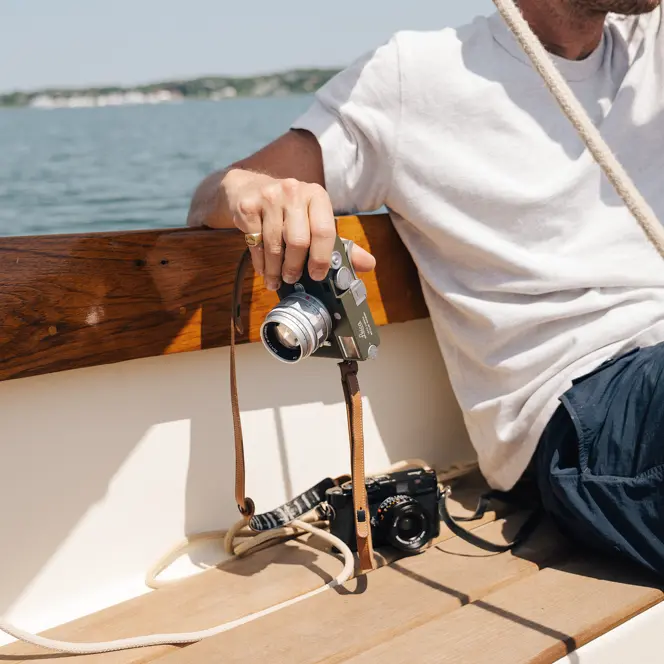 Riley on a boat with his Leica in his hand