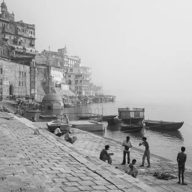 Black-and-white photo of people at a harbour in India