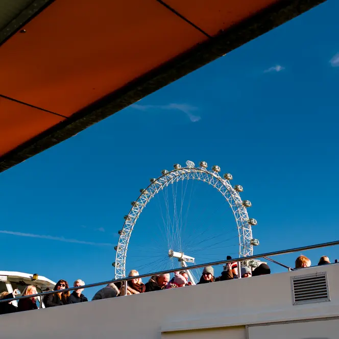 A boat trip on the River Thames in London, with the Ferris wheel visible in the background