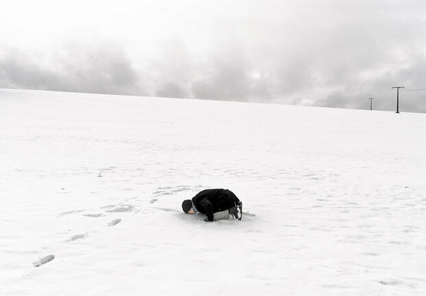 A person laying in snow