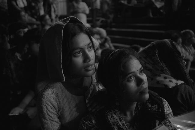 Two girls staring at something in India