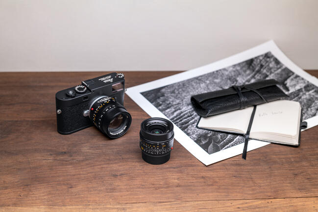 Leica M11-P and Leica Summicron M f2/28mm ASPH. on the desk