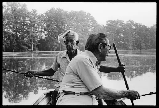 Granddaddy and Sank fishing on a lake in Arkansas. Black-and-white analog photograph from Lisa McCord’s long-term documentary series capturing family, tradition, and rural life.