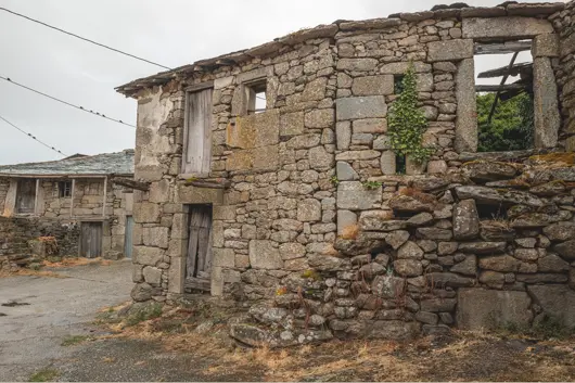 Abandoned stone houses in a depopulated rural village in Spain, illustrating decay, isolation and the changing landscape of España Vacía.