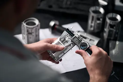 A Leica employee works on a Leica spotting scope