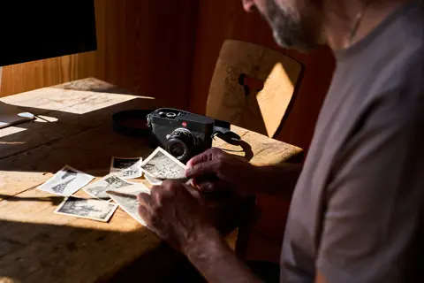 Roland leafed through the vintage photographs